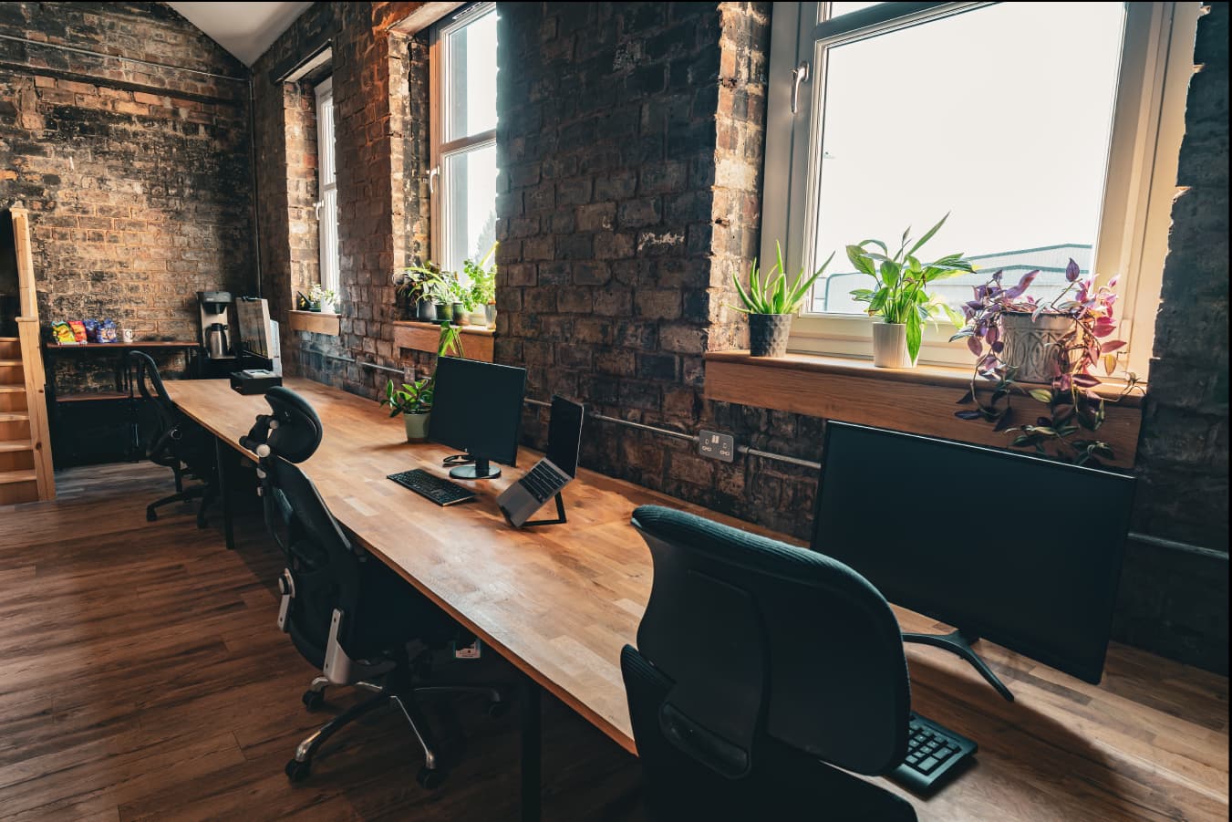 Dedicated desks with natural light and brick walls